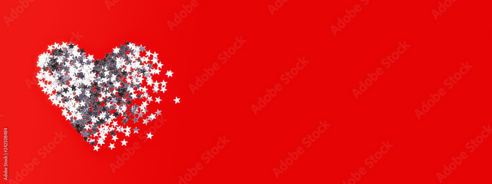 Broken heart made of silver confetti on red background. Valentine's day greeting card. banner for website.