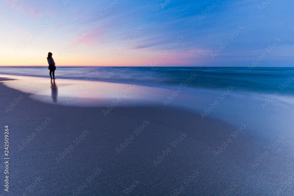 Lonely person at sunset sea. Long exposure landscape Lonely person at sunset sea. Long exposure landscape