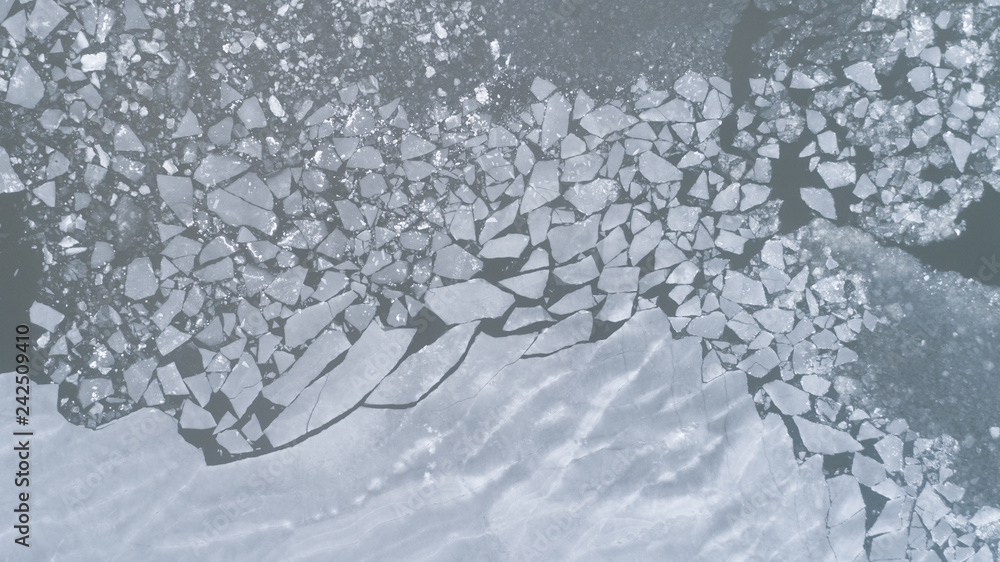 Aerial view of texture of broken blue ice and water at winter. Aerial view of texture of broken blue ice and water at winter.