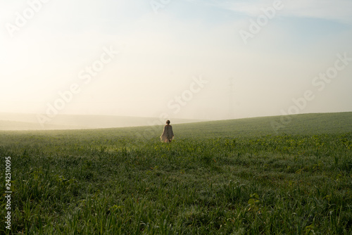 Girl in the morning foggy field