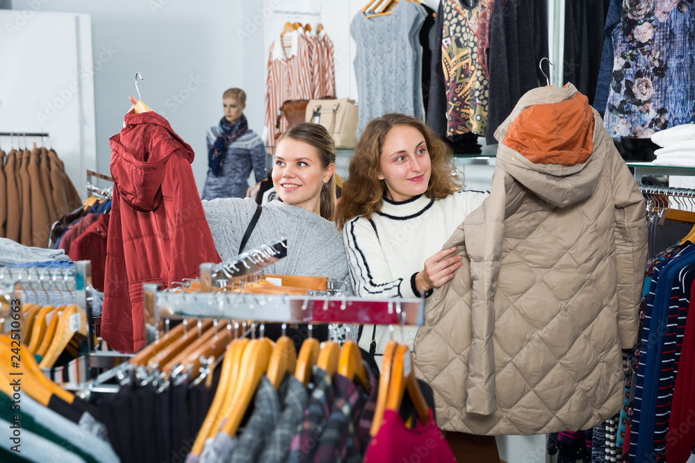Women shopping in outerwear clothing boutique