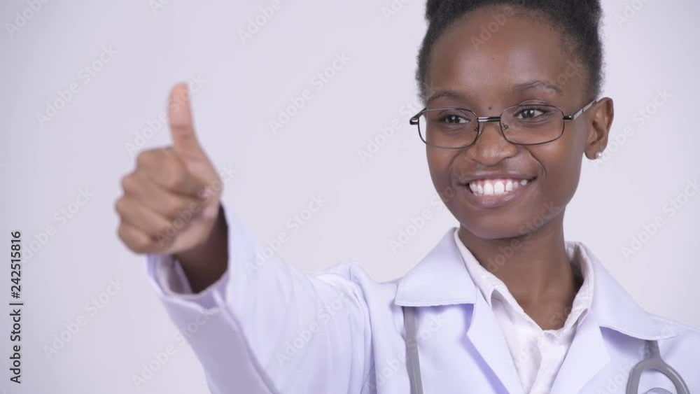 Face of young happy African woman doctor giving thumbs up Face of young happy African woman doctor giving thumbs up