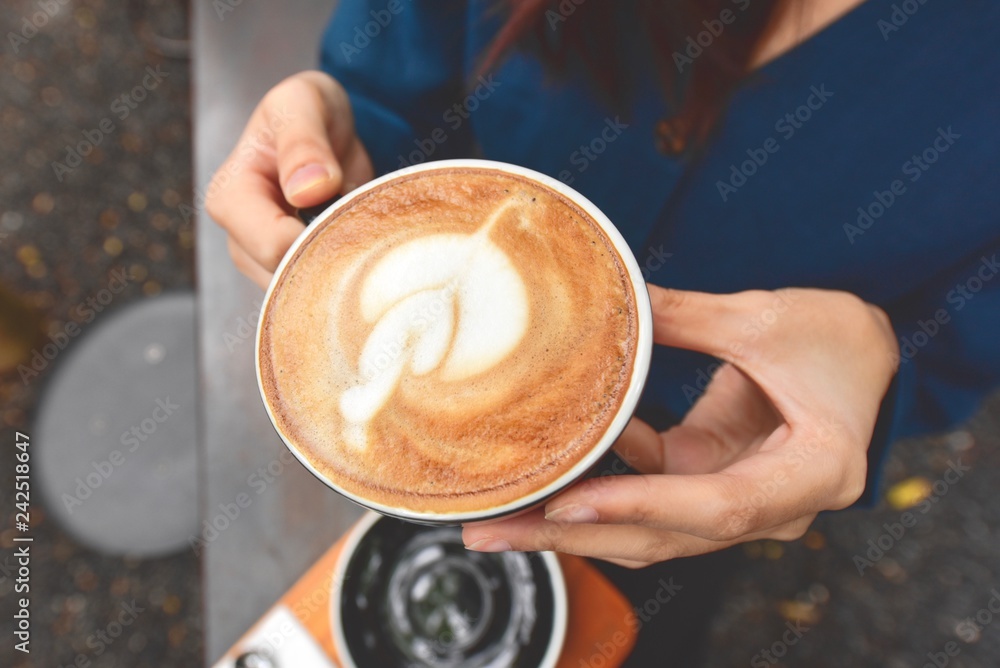 Woman Hands Holding Hot Coffee in a Cup Woman Hands Holding Hot Coffee in a Cup