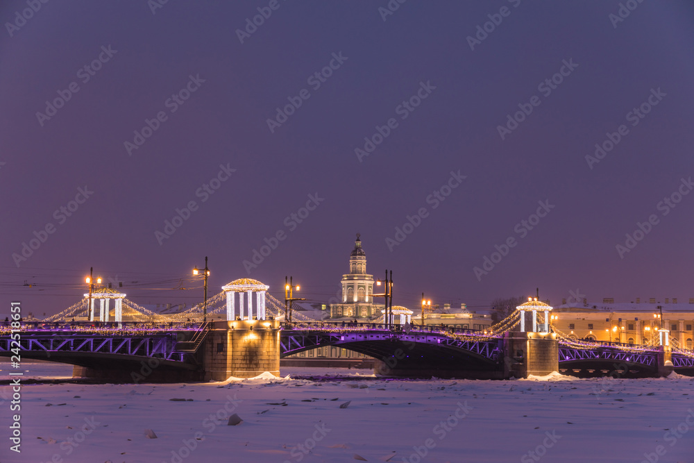  Beautiful Palace Bridge on Neva River in Saint Petersburg in Russia between Palace Square and Vasilievsky Island in the winter time in Christmas or Happy New Year celebration in the evening or night