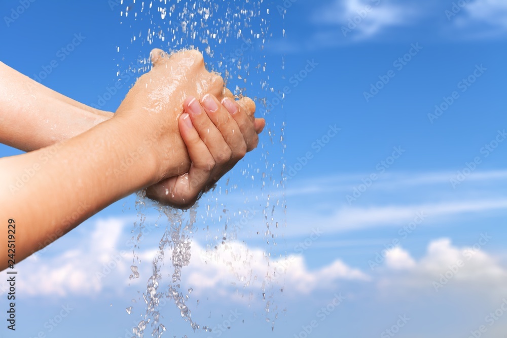 Man washing hands in clean water on blue background Man washing hands in clean water on blue background