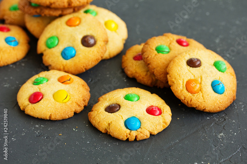 Shortbread cookie with multi-colored sweets and chocolate chips,