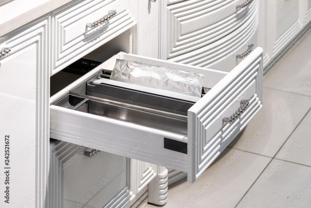 drawer with plates in a modern kitchen drawer with plates in a modern kitchen