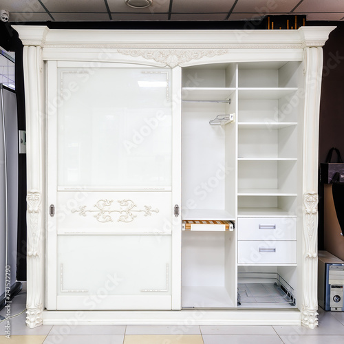 White wardrobe with sliding doors, drawer and shelves, vintage style