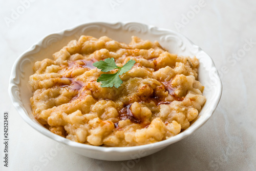 Keskek Traditional Food made with Wheat, Meat and Fried Butter Sauce. photo