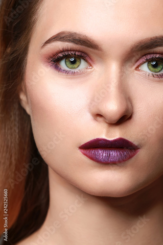 Young woman with makeup in violet tones  closeup