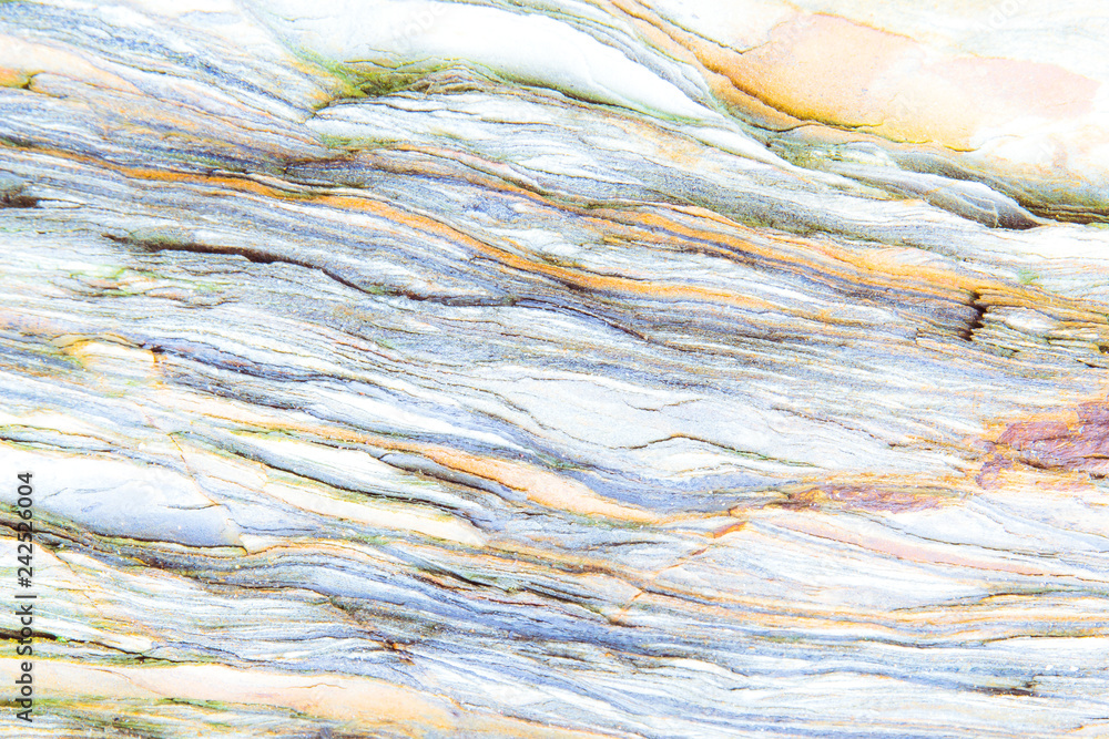 Obraz premium Rock layers - a colorful formations of rocks stacked over the hundreds of years. Interesting background with fascinating texture