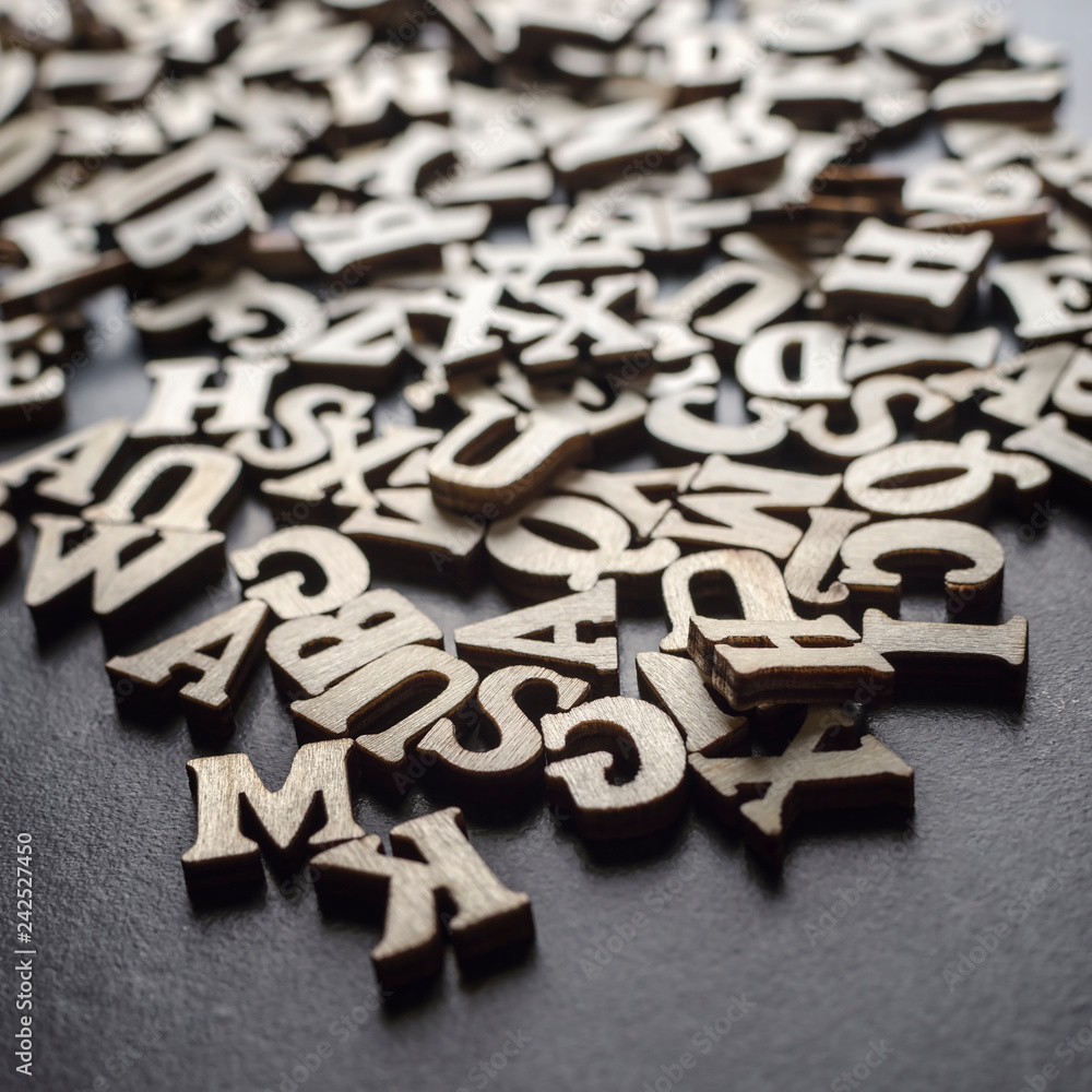 Wooden alphabets on a dark woode background Wooden alphabets on a dark woode background