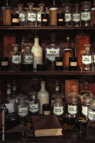 Wooden shelves with old bottles in an old retro apothecary shop