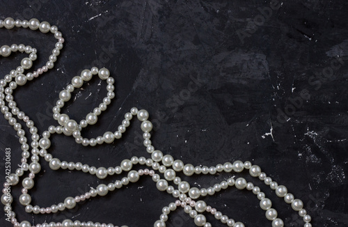 white pearl beads on black background,