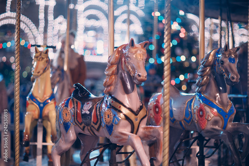 A young woman rides a merry-go-round with horses at the New Year's Fair