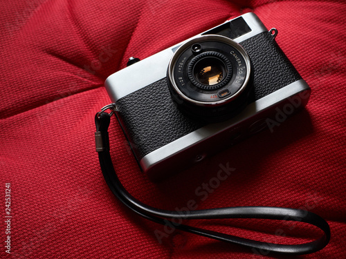 Isolated film camera with hand strap.