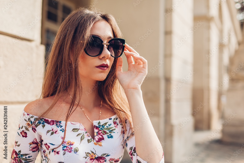 Outdoor portrait of young beautiful fashionable woman wearing stylish sunglasses. City fashion. Makeup