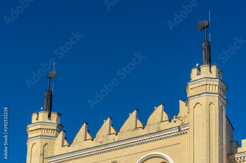 LUBLIN, POLAND - Juni 07, 2018: The main entrance gate detail of the Neo-Gothic part of the Lublin Castle with axes. The medieval royal castle is in city center photo