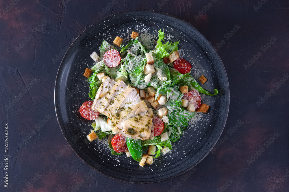 Fried chicken fillet with arugula, tomato cherry, corn salad sprinkled with grated cheese and bread chips Fried chicken fillet with arugula, tomato cherry, corn salad sprinkled with grated cheese and bread chips