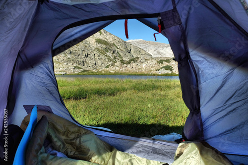 Camping at near Sakligol Lake (Bursa). View from inside the tent. Green grass and lake. Outdoor Lifestyle. photo