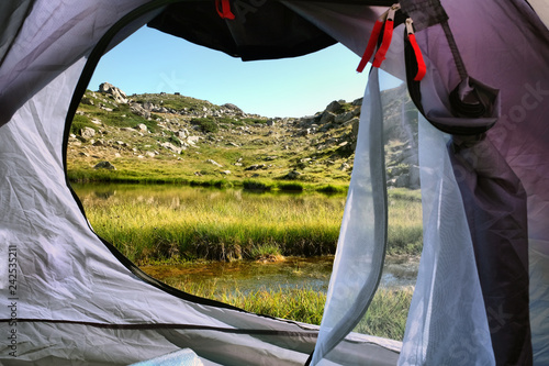 Camping at near Sakligol Lake (Bursa). View from inside the tent. Green grass and lake. Outdoor Lifestyle. photo