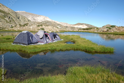 Camping tents on an grassy island at a (Sakligol) Lake, Bursa photo