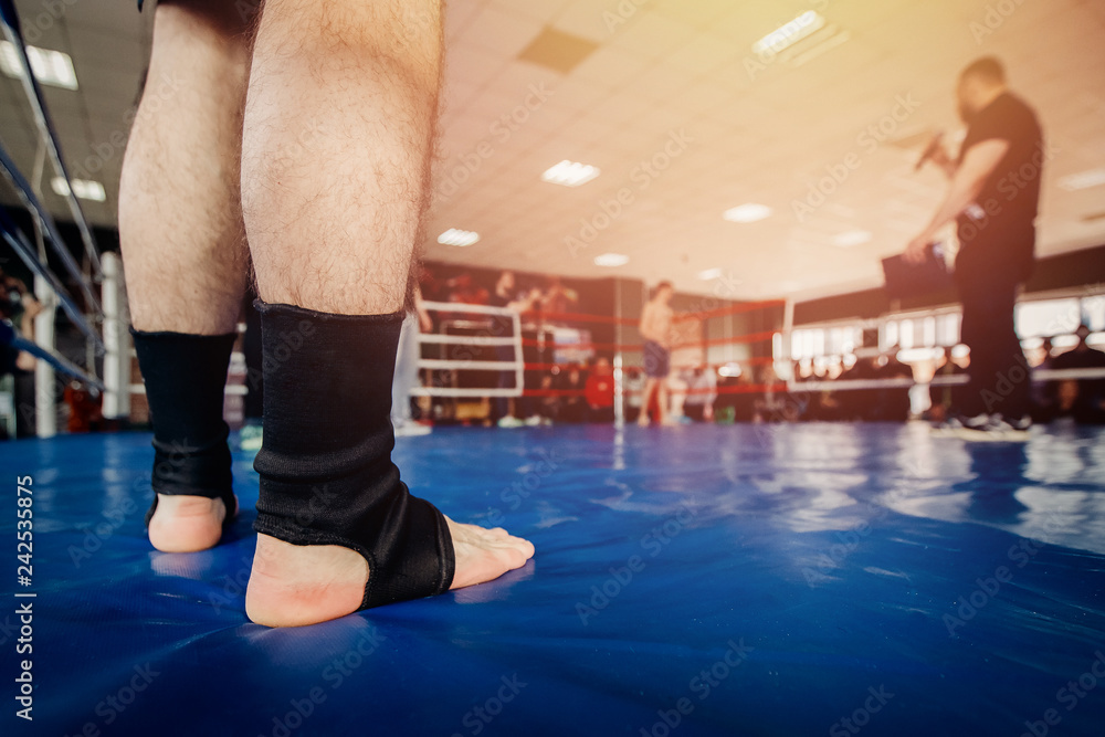 MMA fighter prepares to fight in ring, close-up legs in socks