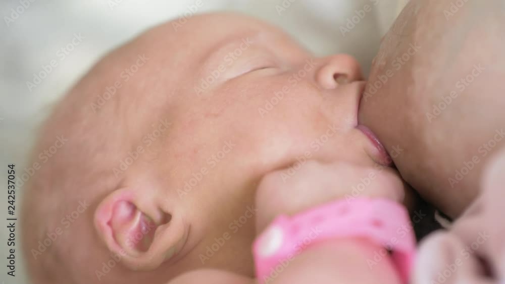 Close-up shot of mother breastfeeding newborn baby girl Close-up shot of mother breastfeeding newborn baby girl