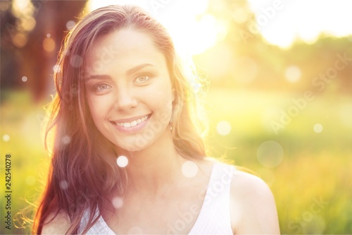 Young woman on field under sunset light