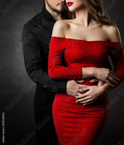 Couple Fashion Beauty, Young Woman in Sexy Red Dress and Embracing Man in Love