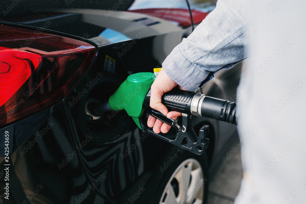 Close up of man refilling tank on his car on the gas station. Close up of man refilling tank on his car on the gas station.