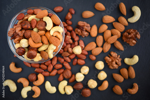 Assorted nuts on stone background.