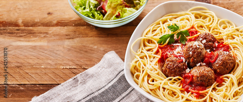 Serving of spicy mini meatballs with noodles photo