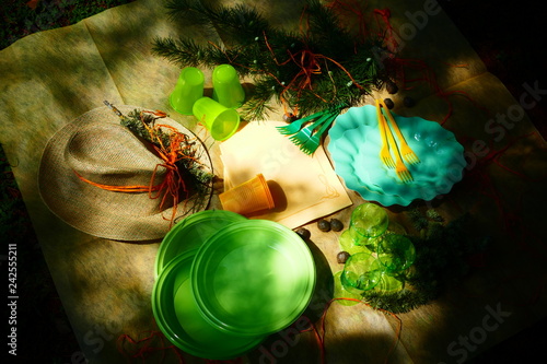 Picnic with plastic plates and dishes outdoor. Romantic date in the mountain