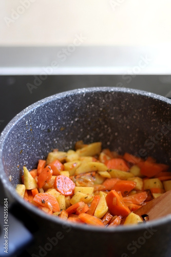 Cooking carrot, potao and onion for stew. Selective focus. photo