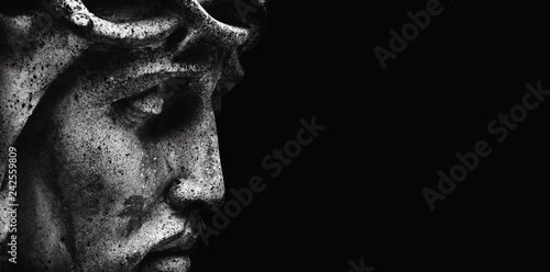 Jesus Christ in profile. An ancient statue. Religion, faith, death, suffering, immortality, God concept. photo