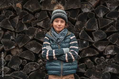 Portrait of a boy on the background of a wooden surface.