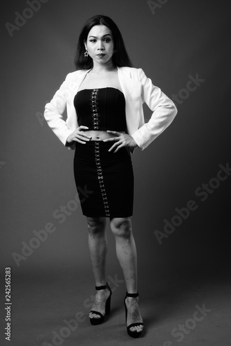 Full length portrait of transgender businesswoman in black and white