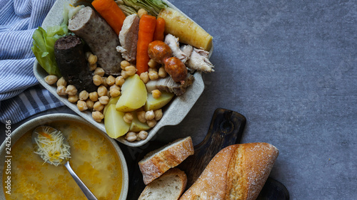 Cocido, traditional chickpea-based stew from Madrid. on the grey stone background photo