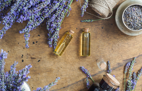 lavender oil bottles,  natural herb cosmetic consept with lavender flowers flatlay on stone background