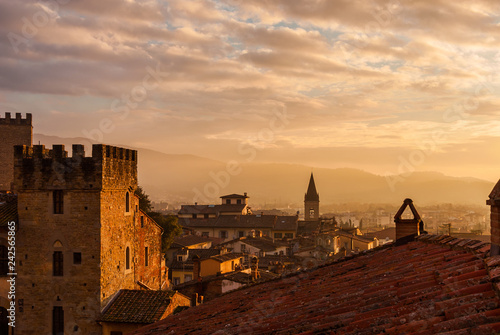 View of Arezzo historic center sunset skyline with old medieval towers, churches and mist