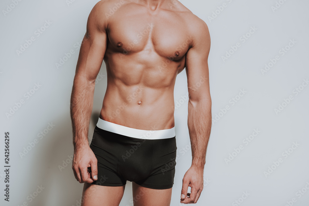 Close up of muscular man standing in black underwear - obrazy, fototapety, plakaty 
