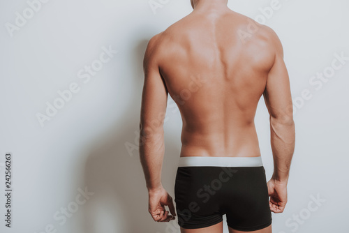 Back of young caucasian man standing in black underwear Stock Photo