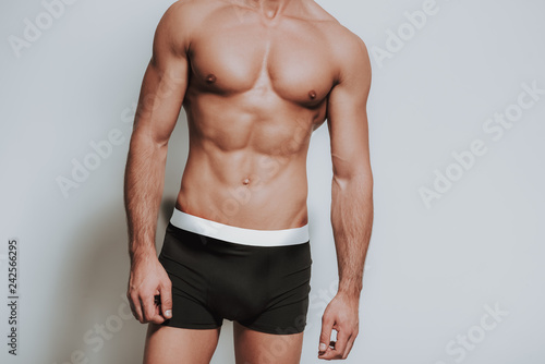 Close up of muscular man standing in black underwear photo