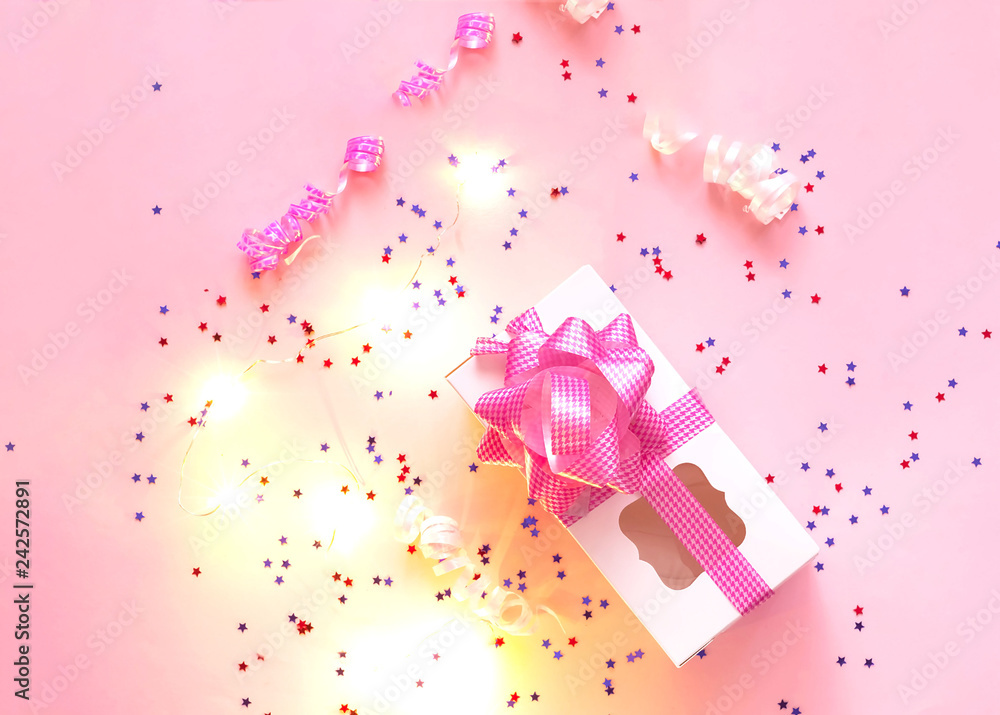 Festive garland of small light bulbs and stars on pink pastel trendy background. Festive garland of small light bulbs and stars on pink pastel trendy background.