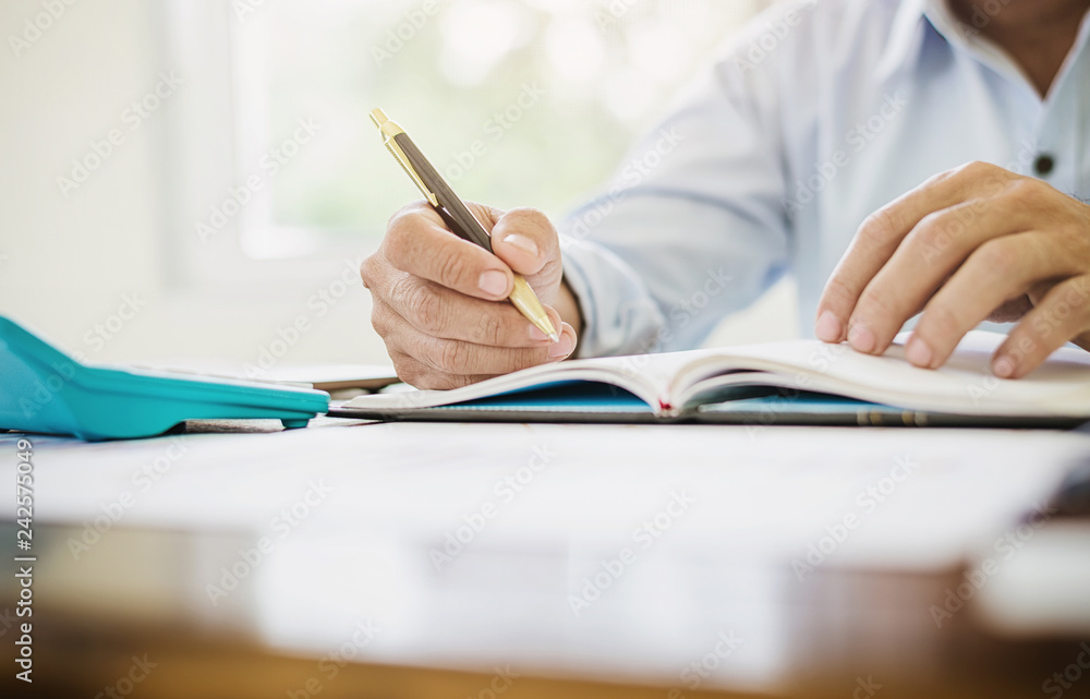 Accountant man calculating tax expense financial statement. Accountant man calculating tax expense financial statement.