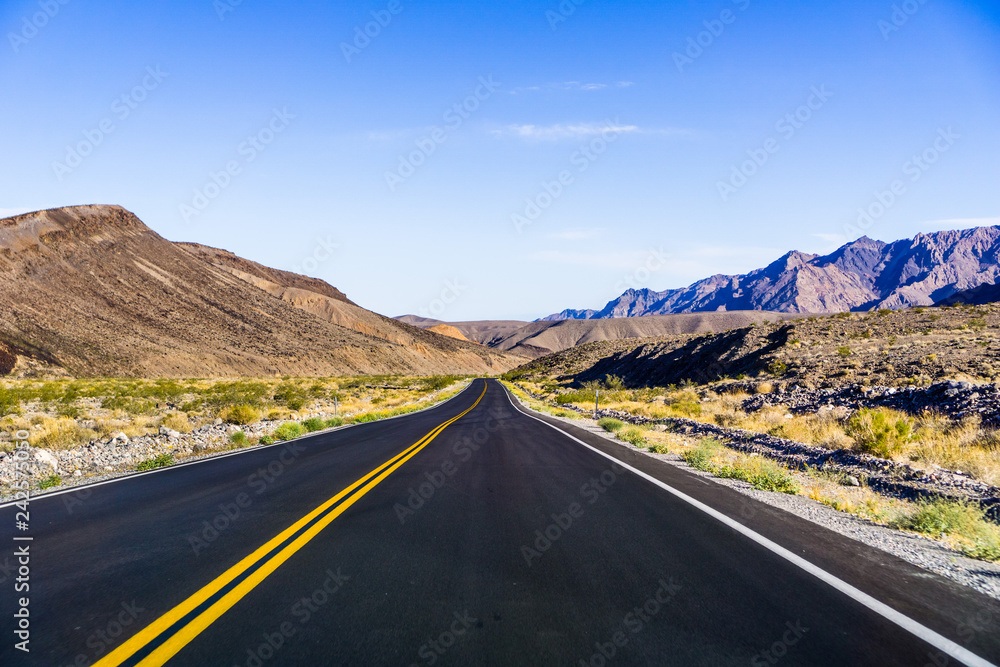 Morning view of the highway crossing Death Valley National Park, California