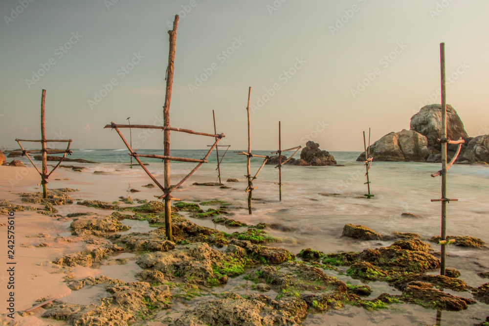 Long Exposure photography of Koggala Beach Sri Lanka with Coral Reefs and Fisherman Sticks
