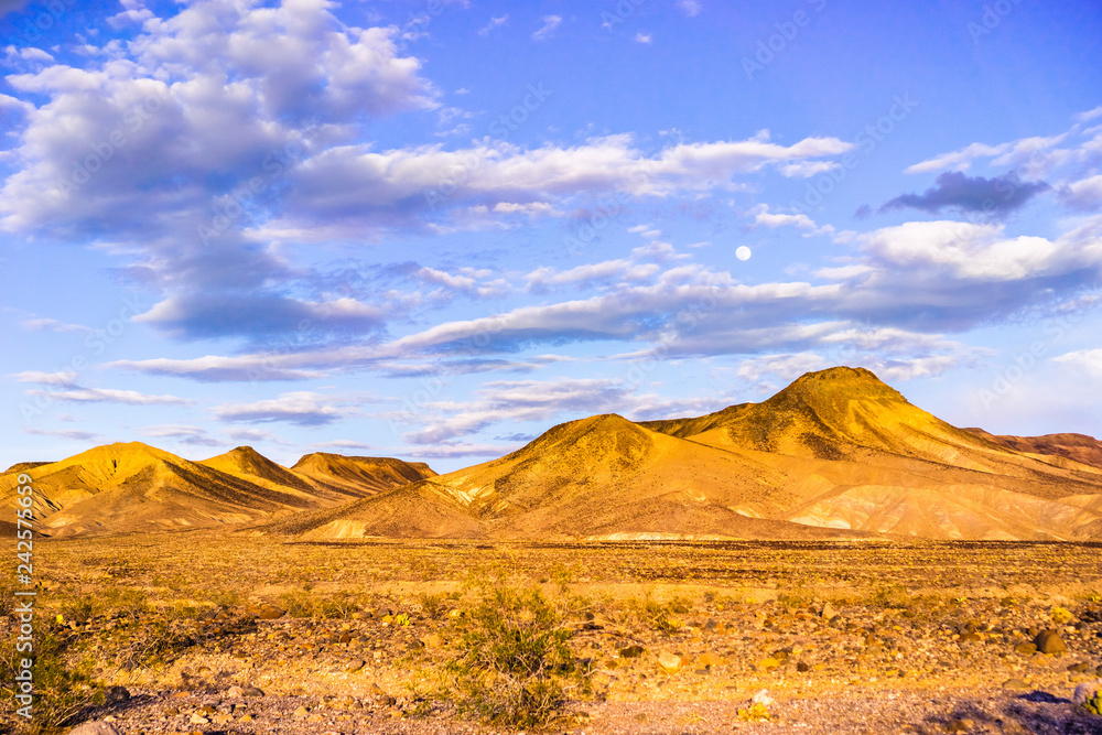 Beautiful sunset landscape, full moon up in the sky, Death Valley National Park, California