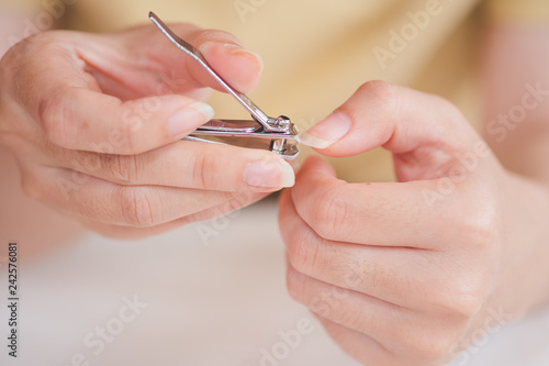 Closeup of a woman cutting nails  health care concept  selective focus.